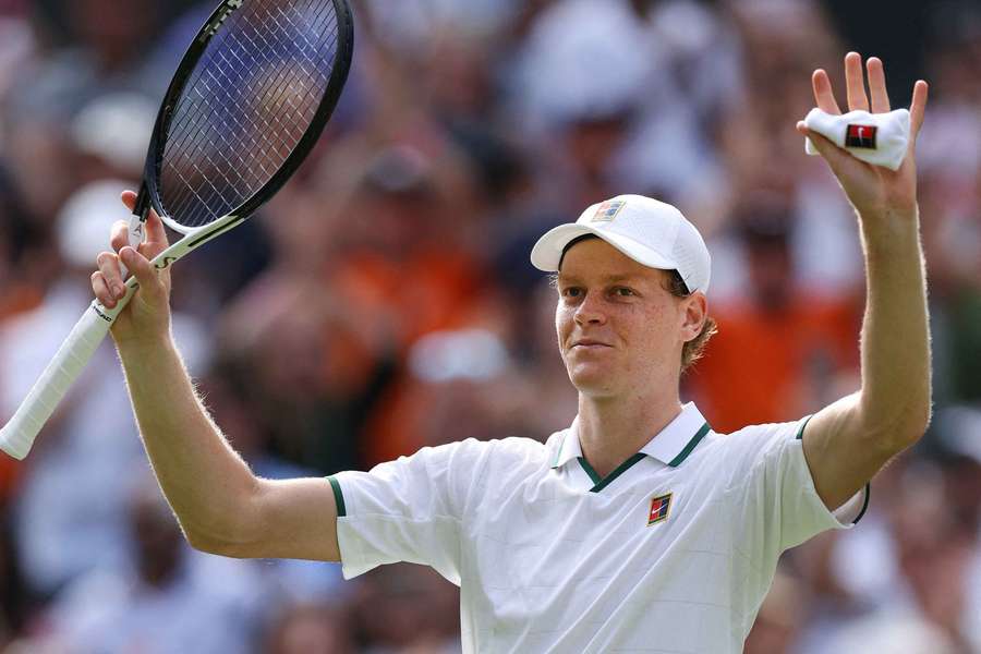 Jannik Sinner celebrates winning his first-round match against Serbia's Miomir Kecmanovic at Wimbledon