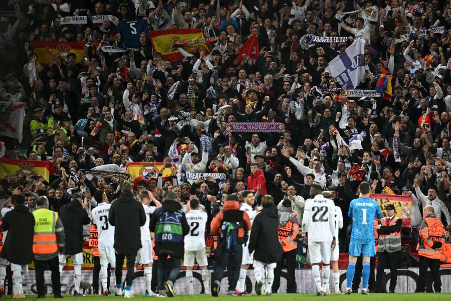 Madrid's players celebrate in front of the travelling fans