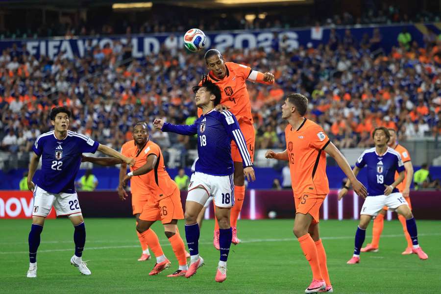 Virgil Van Dijk wins an aerial duel with Japan's Ayase Ueda. Virgil Van Dijk wins an aerial duel with Japan's Ayase Ueda.