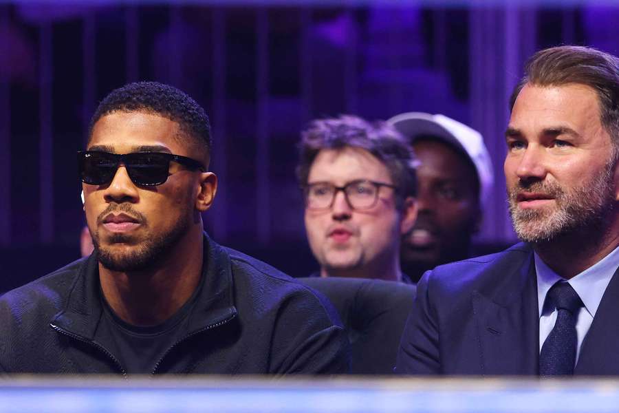 Anthony Joshua, left, was described as 'brave-faced and positive' by promoter Eddie Hearn