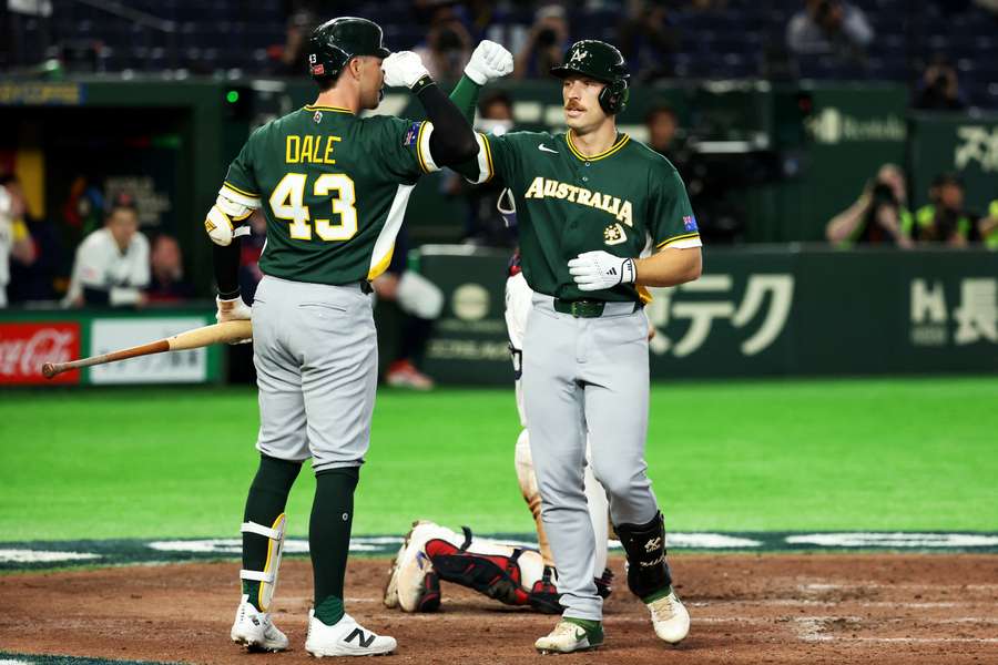 Australia's Alex Hall (right) celebrates a home run with Jarryd Dale at 2026 World Baseball Classic
