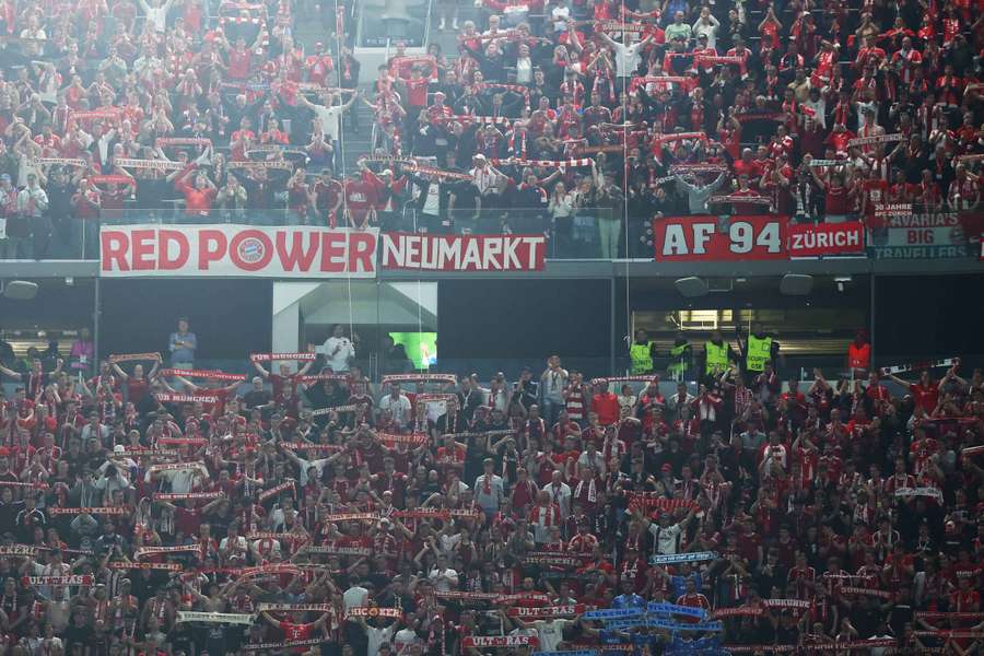 Bayern Munich fans celebrate in the stands after the match