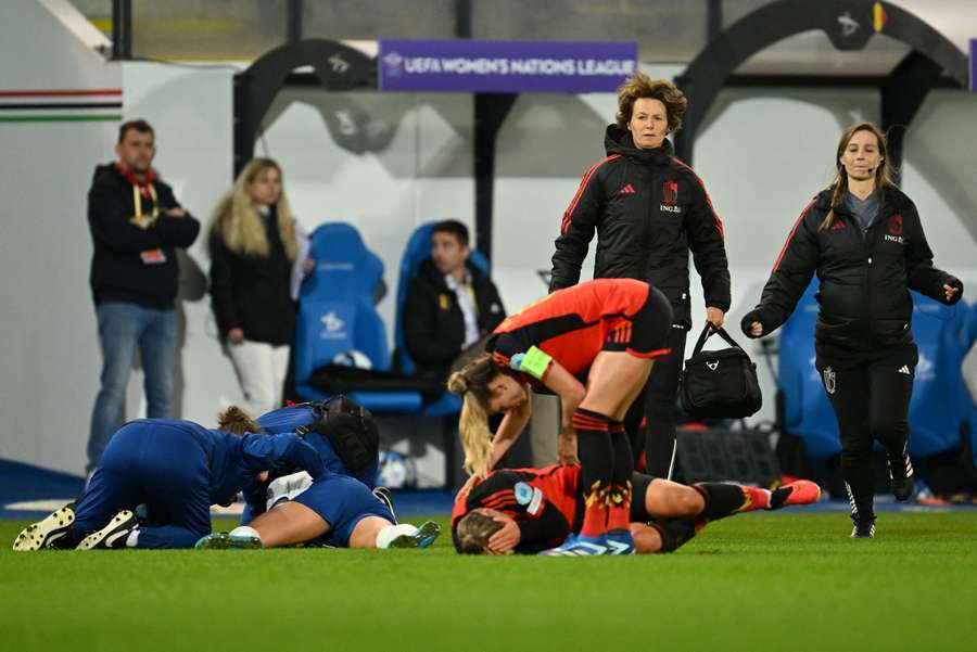 England's Alex Greenwood and Belgium's Jassina Blom laying down injured