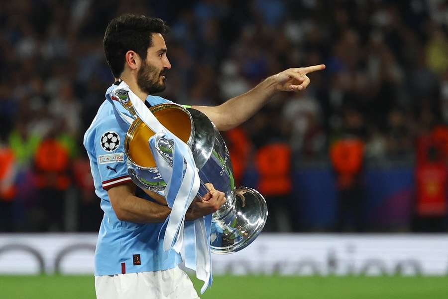 Ilkay Gundogan holds the Champions League trophy after City beat Inter in the final