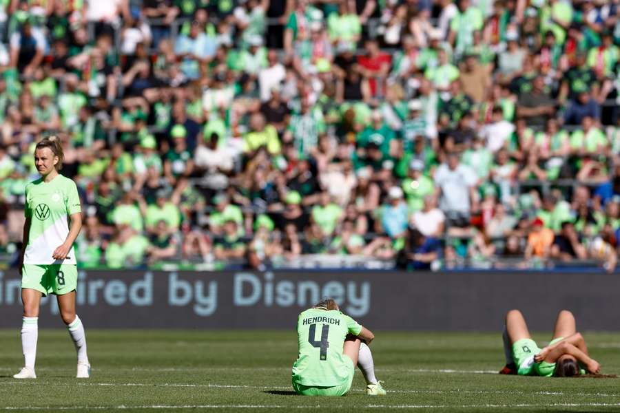 Wolfsburg team players react to their team's defeat