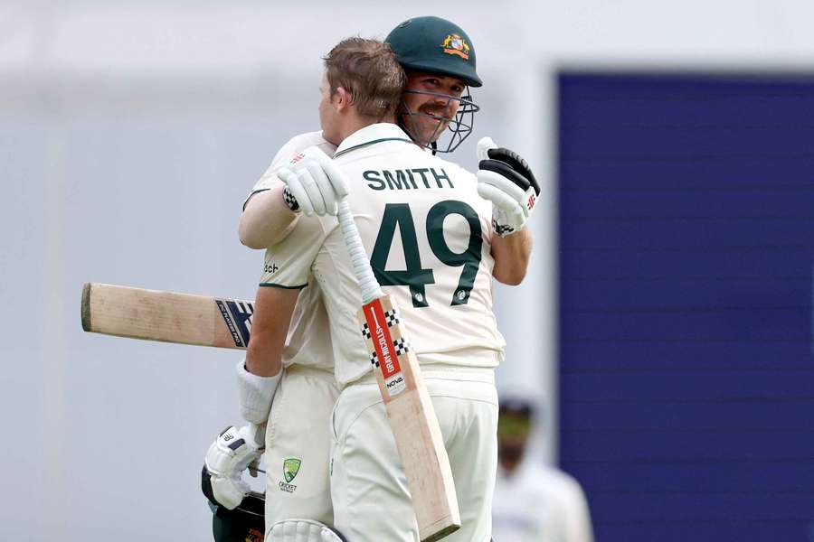 Steve Smith celebrates his century with teammate Travis Head