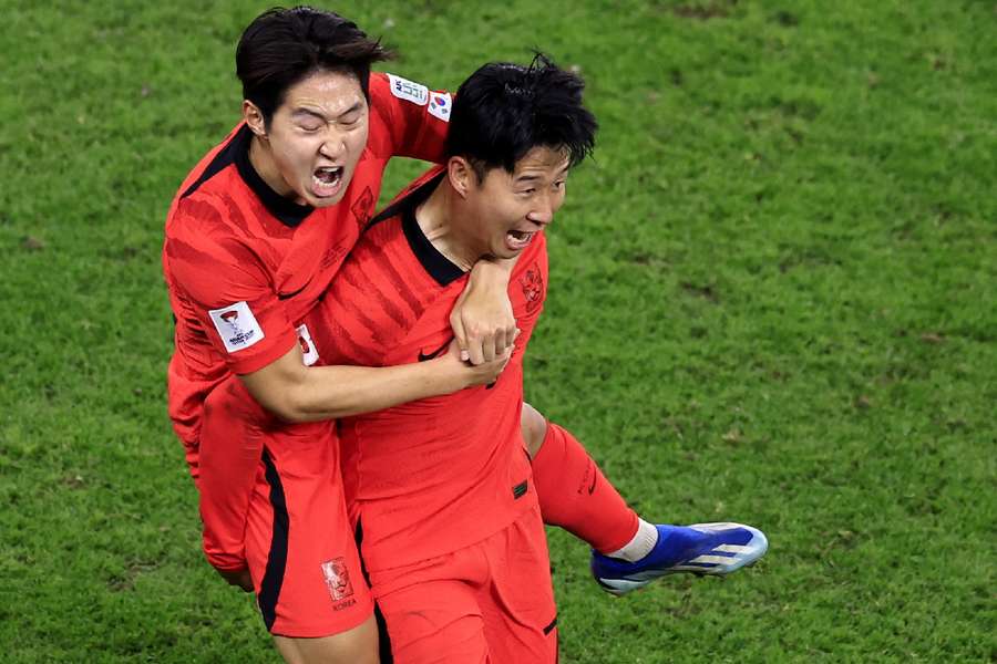 South Korea's Son Heung-Min (R) celebrates scoring in the Asian Cup with Lee Kang-In