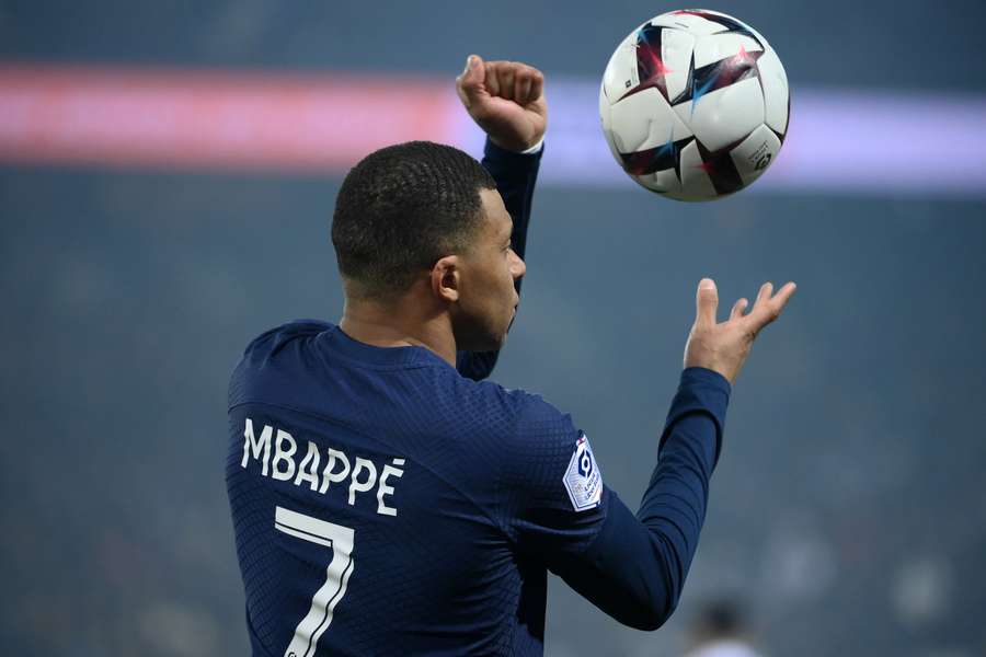 Paris Saint-Germain's French forward Kylian Mbappe holds the ball