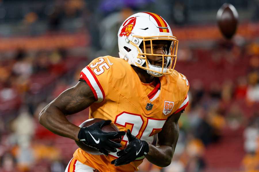 Jamel Dean warms up before a game