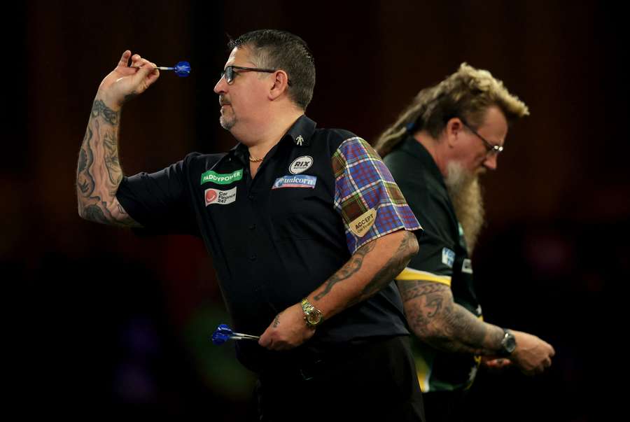 Gary Anderson of Scotland throws in his Second Round match against Simon Whitlock of Australia