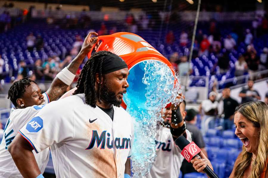 Miami's Josh Bell is given a bath after the game