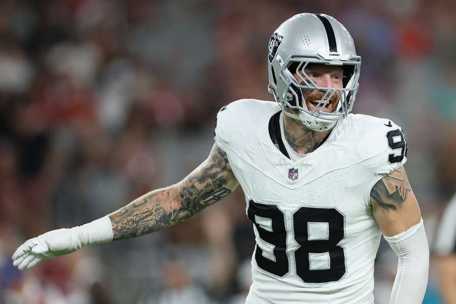 Maxx Crosby smiles during a game