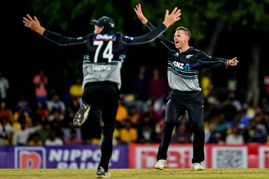 New Zealand's Lockie Ferguson (right) celebrates after taking the wicket of Sri Lanka captain Charith Asalanka