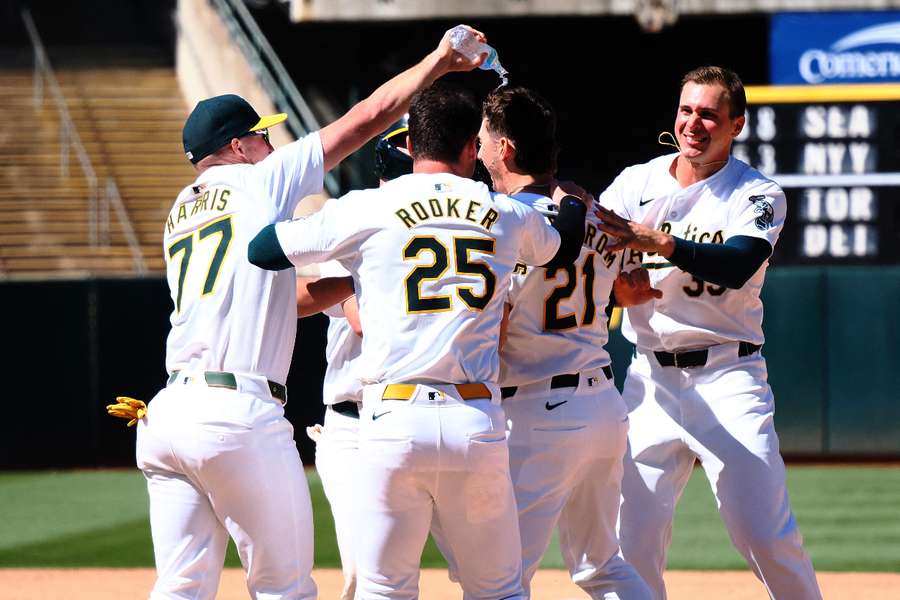Oakland Athletics pinch hitter Tyler Soderstrom celebrates with teammates after a walk-off win against the Colorado Rockies