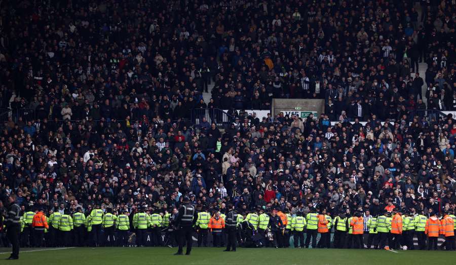 Police line the edge of the pitch after trouble breaks out between fans during the English FA Cup fourth round football match between West Bromwich Albion and Wolverhampton Wanderers