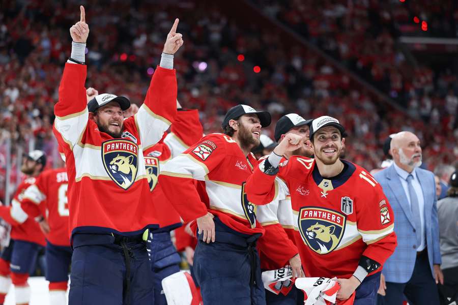 Evan Rodrigues, Carter Verhaeghe and Sam Reinhart of the Florida Panthers celebrate after defeating the Edmonton Oilers to win the Stanley Cup