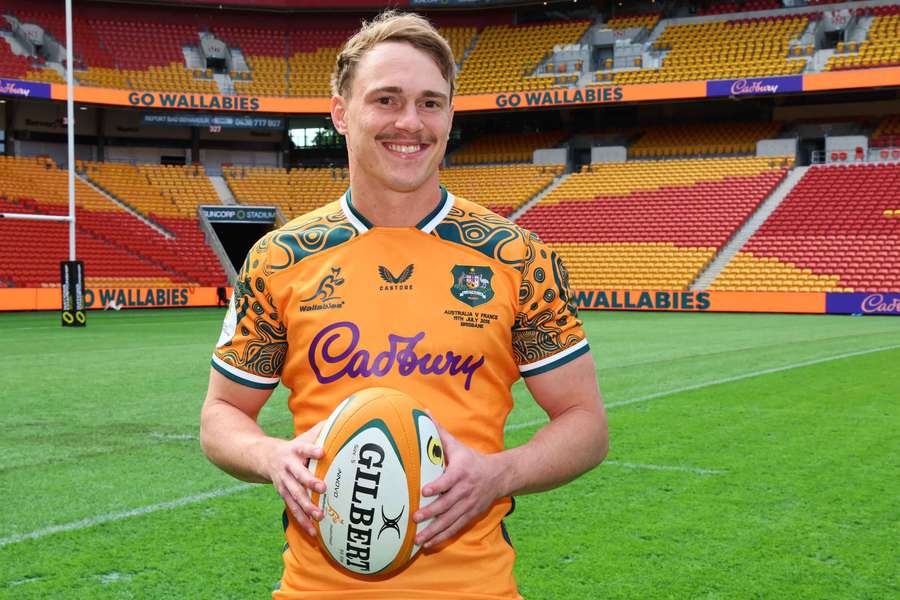 A proud Declan Meredith poses for photographers at Friday's captains run in Brisbane.