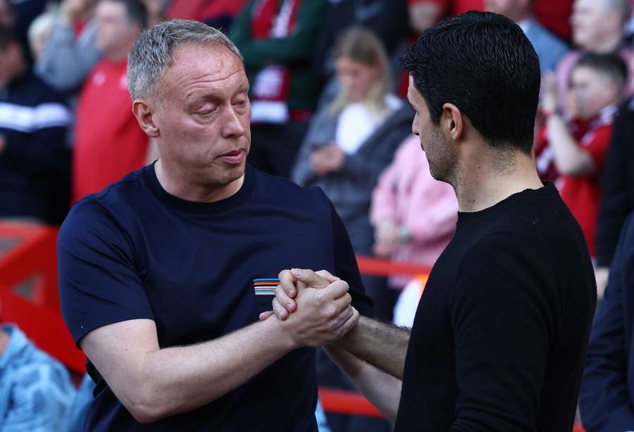 Nottingham Forest's Welsh manager Steve Cooper (L) greets Arsenal's Spanish manager Mikel Arteta ahead of the English Premier League football match between Nottingham Forest and Arsenal