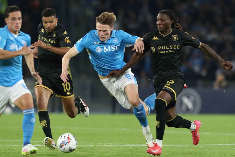 Napoli's Scott McTominay (centre) fights for the ball with Genoa's Junior Messias