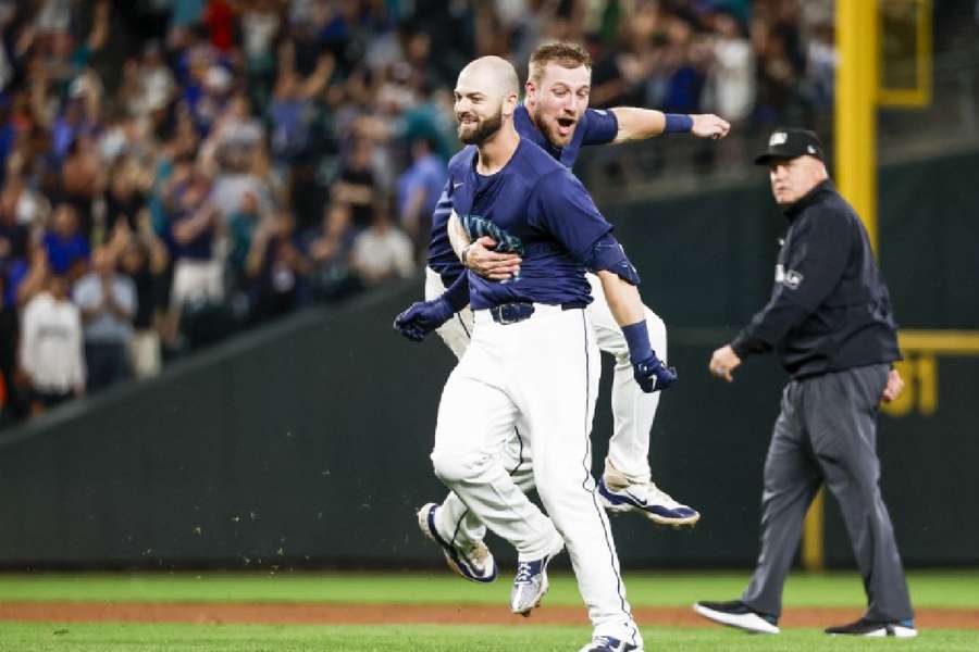 Mitch Haniger celebrates with first baseman Luke Raley