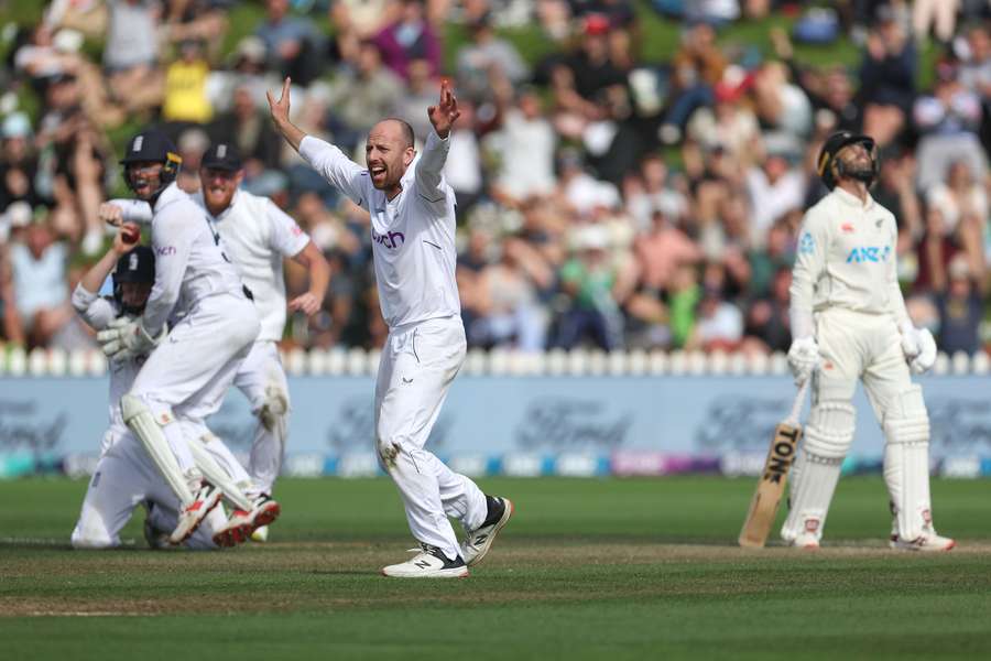 England's Jack Leach (C) cheers after a successful appeal for a catch 