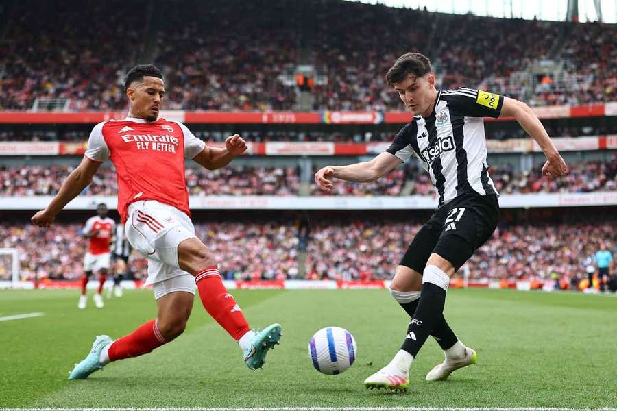 Newcastle's Tino Livramento competes with Arsenal's William Saliba for the ball