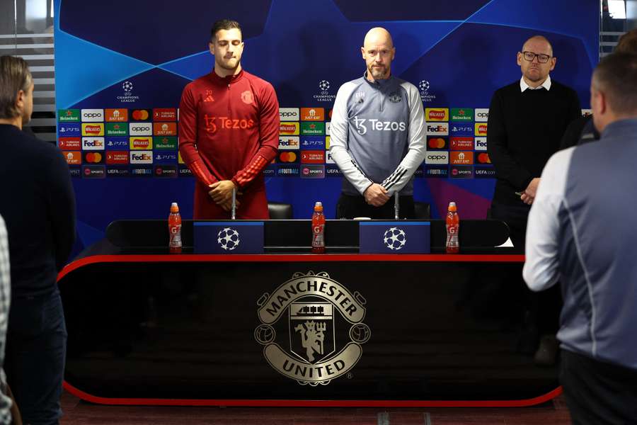 Diogo Dalot and Erik ten Hag hold a minute's silence in memory of former player Bobby Charlton before Monday's press conference