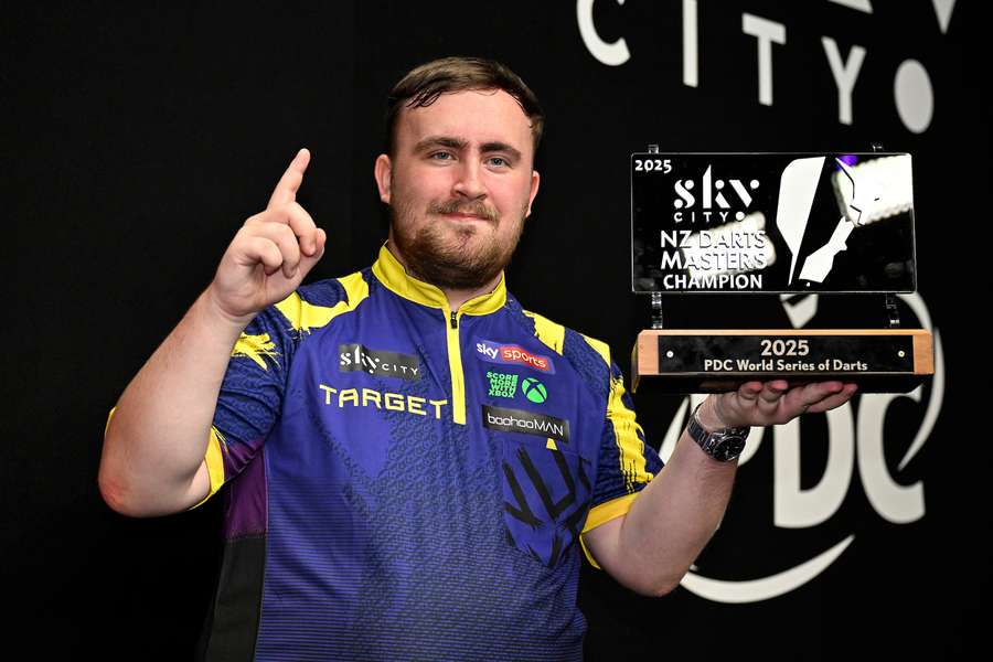 Luke Littler poses with the NZ Darts Masters trophy