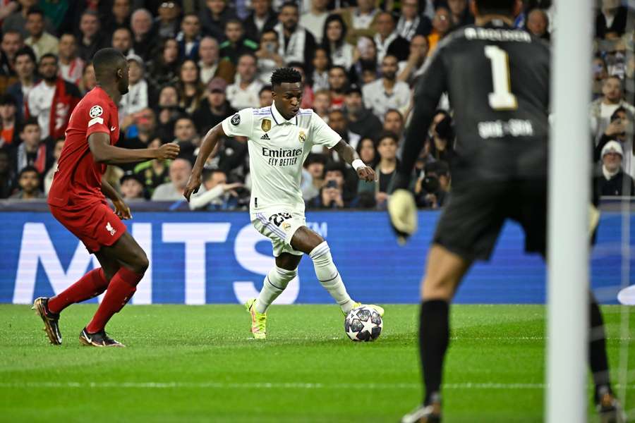 Vinicius drives the ball against Liverpool