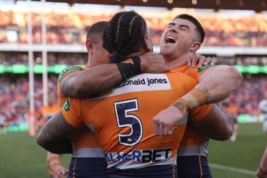 Greg Marzhew and his Newcastle Knights teammates celebrate a try during Sunday's narrow loss to the Warriors.