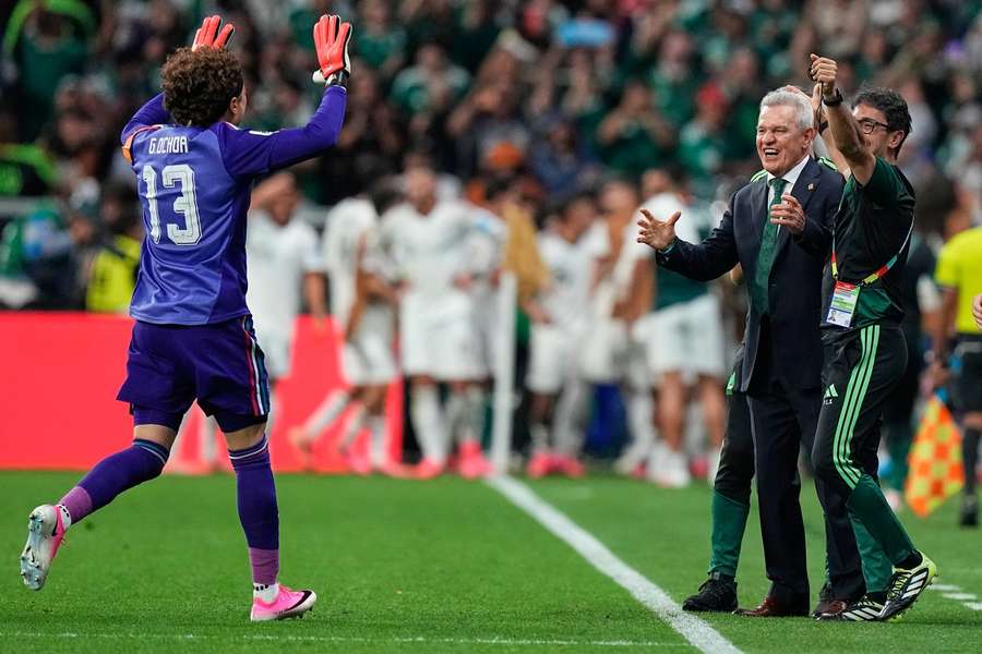 Ochoa runs to Javier Aguirre during his final Mexico match Ochoa runs to Javier Aguirre during his final Mexico match