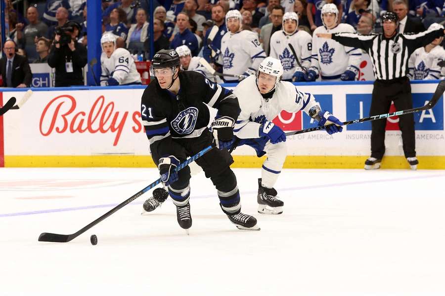 Tampa Bay Lightning centre Brayden Point skates with the puck as Toronto Maple Leafs left-wing Tyler Bertuzzi defends 