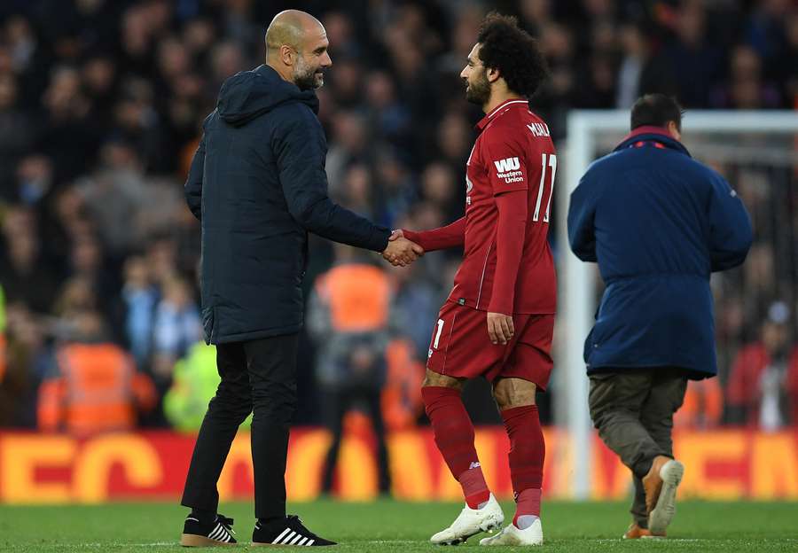 Manchester City's Pep Guardiola with Liverpool's Mohamed Salah