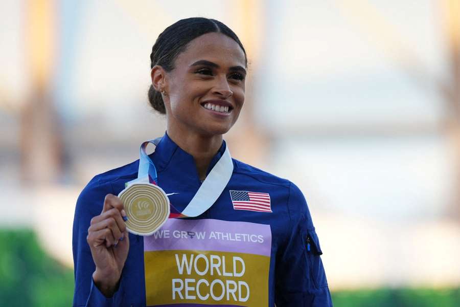 Sydney McLaughlin celebrates after winning the women's 400 metres hurdles final and setting a world record