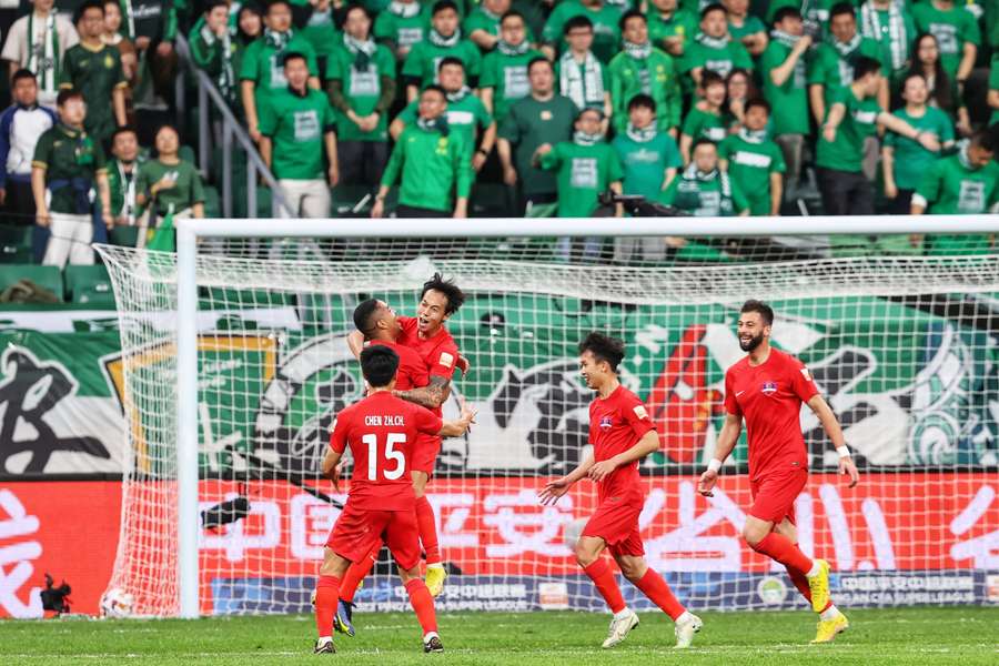 Meizhou Hakka's players celebrate after scoring Meizhou Hakka's players celebrate after scoring