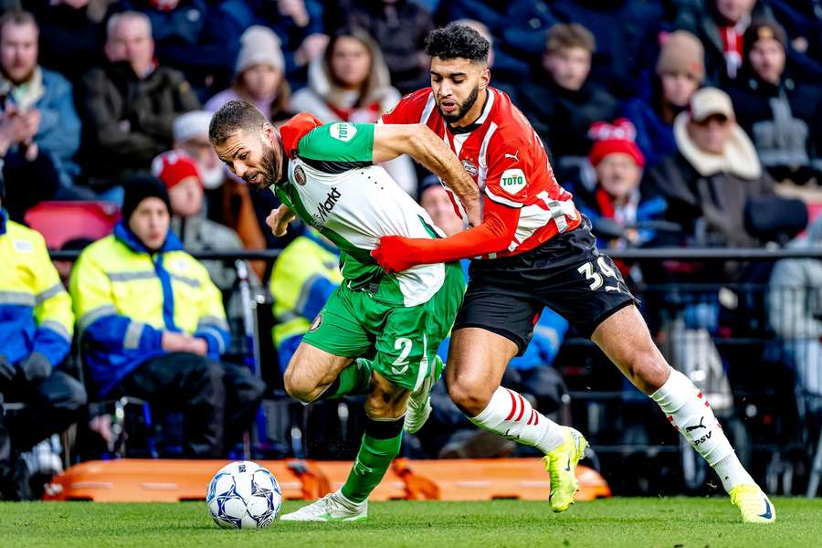 Bart Nieuwkoop (L) of Feyenoord and PSV's Ismael Saibari battling it out during the last Eredivisie meeting between the two teams