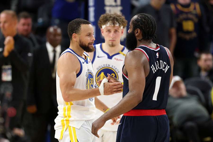 Steph Curry and James Harden embrace after the Clippers' victory over the Warriors