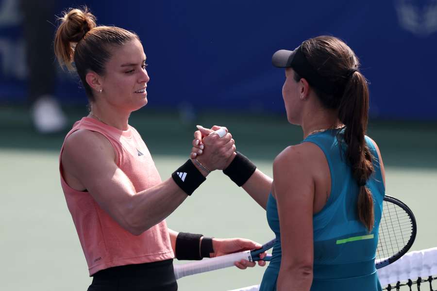 Sakkari (R) shakes hands with Pegula after their match