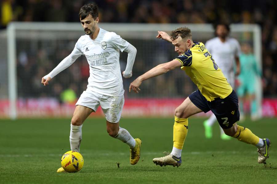 Arsenal's Portuguese midfielder Fabio Vieira fights for the ball with Oxford United's English defender Sam Long