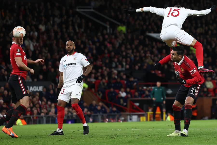 Sevilla's Moroccan forward Youssef En-Nesyri headers the ball to score a second goal, deflected in for an own goal off of Manchester United's English defender Harry Maguire