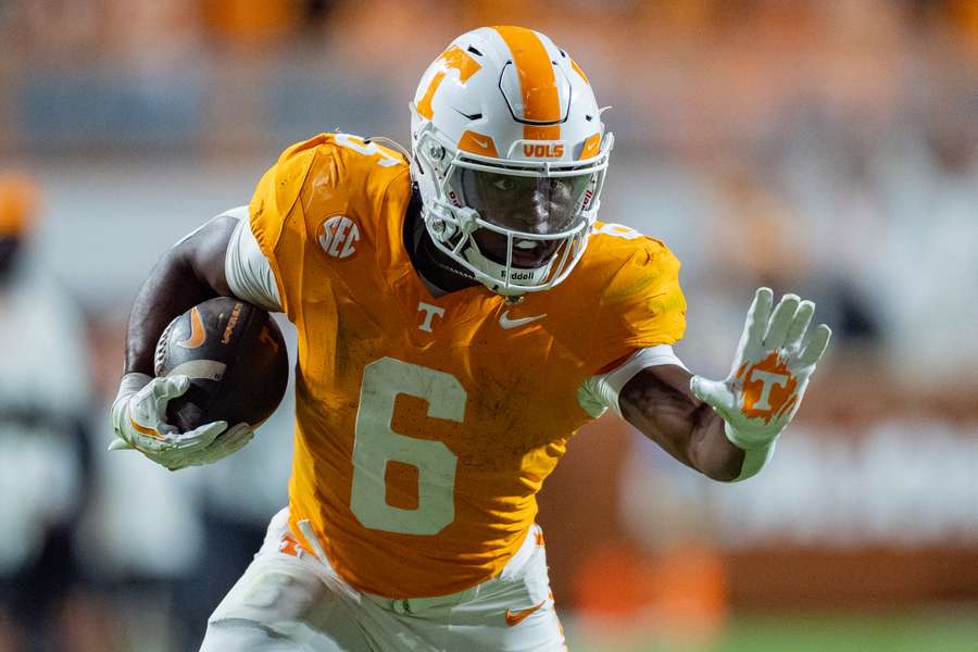 Tennessee running back Dylan Sampson getting ready to stiff arm a defender