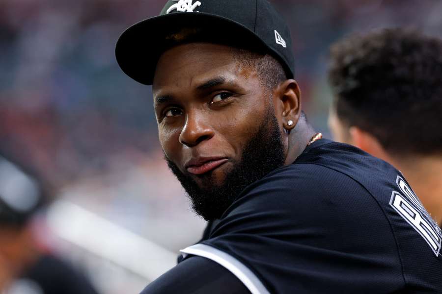 Luis Robert Jr. smiling in the dugout