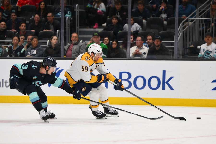 Nashville Predators defenseman Roman Josi advances the puck while defended by Seattle Kraken defenseman Will Borgen