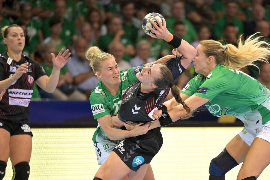 Team Esbjerg's Live Rushfeldt Deila is challenged by Veronica Kristiansen and Kristine Breistol from Gyor