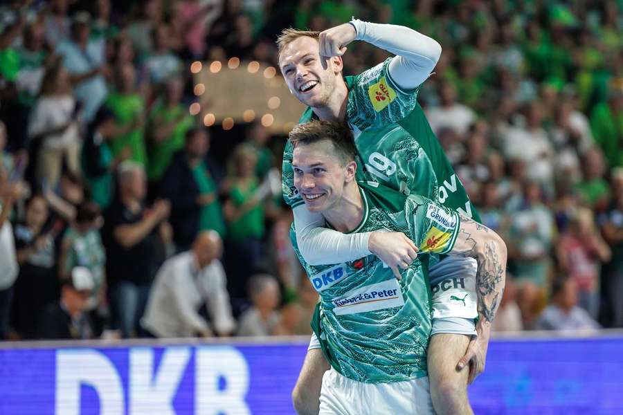 Matias Gidsel celebrates with team-mate Lasse Andersson