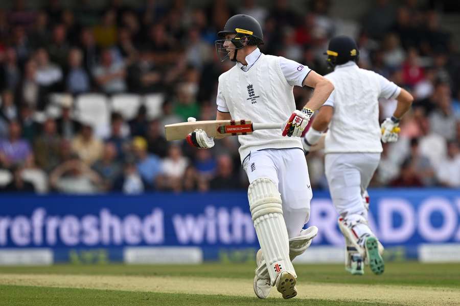 England's Zak Crawley (L) and England's Joe Root (R) take a run on day one of the third Ashes cricket Test match