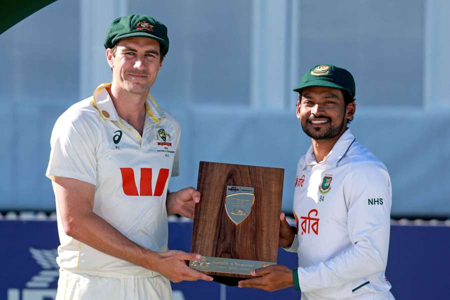 Pat Cummins and Najmul Hossain Shanto hold the trophy after the drawn series Pat Cummins and Najmul Hossain Shanto hold the trophy after the drawn series