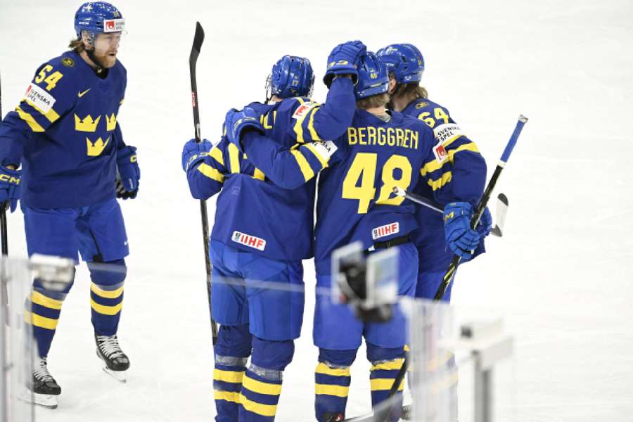 Swedish players celebrate a goal against Austria