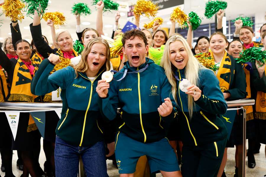 Daisy Thomas, Cooper Woods and Danielle Scott pose with their Olympic medals. Daisy Thomas, Cooper Woods and Danielle Scott pose with their Olympic medals.