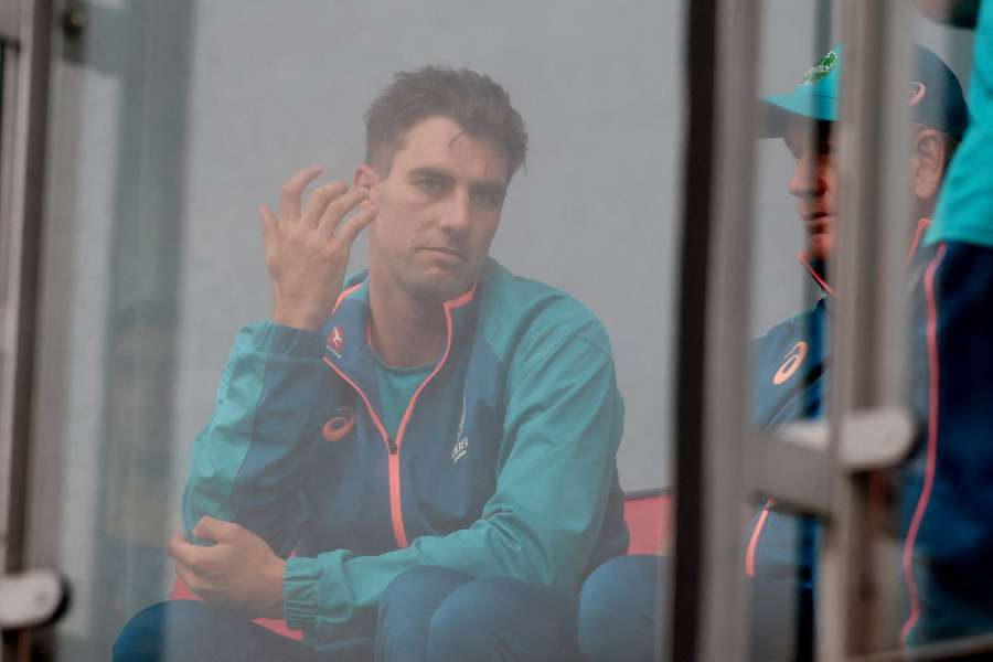 Captain Cummins watches on as the rain intervenes